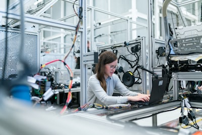 Engineer using a laptop in an industrial workshop